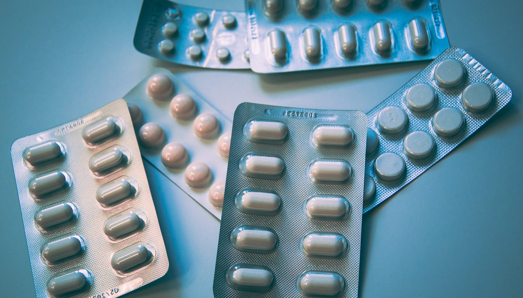 Premium supplement bottles on dark background with golden lighting